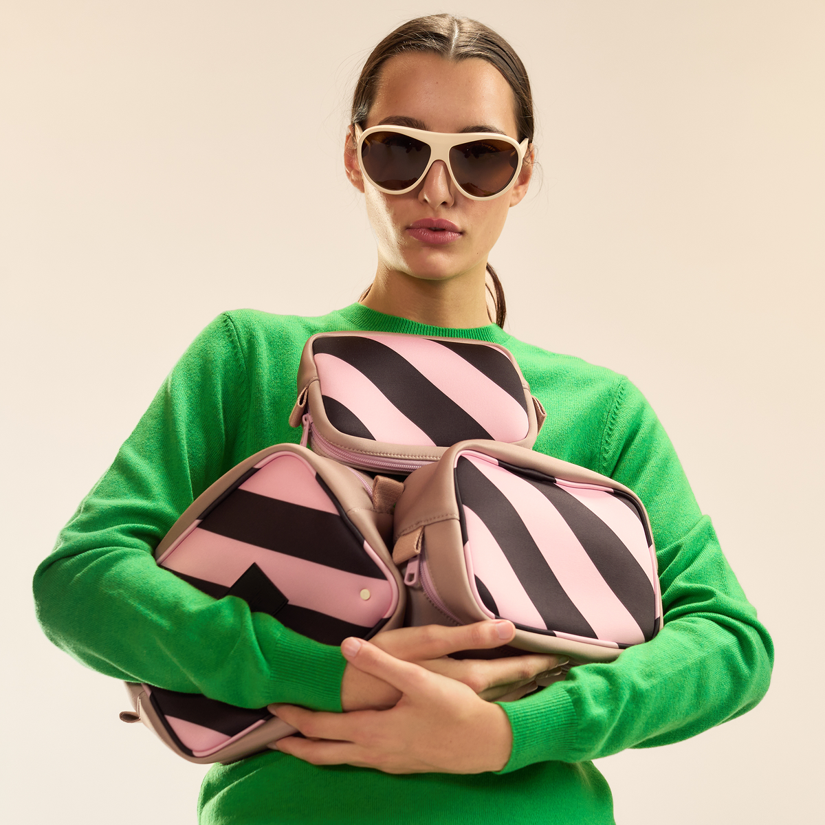 Girl Holding STATE Bags x Cynthia Rowley Travel Pouch Set of Three Stripes