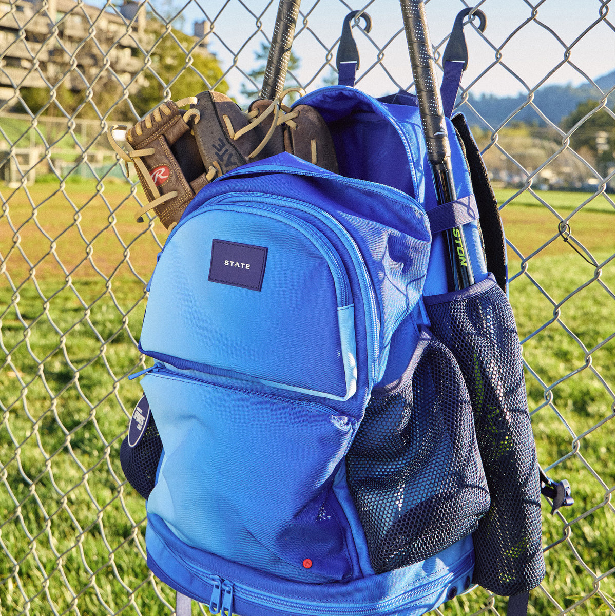 STATE Bags Shea Baseball Backpack Blue Gradient hanging on fence Click to Zoom