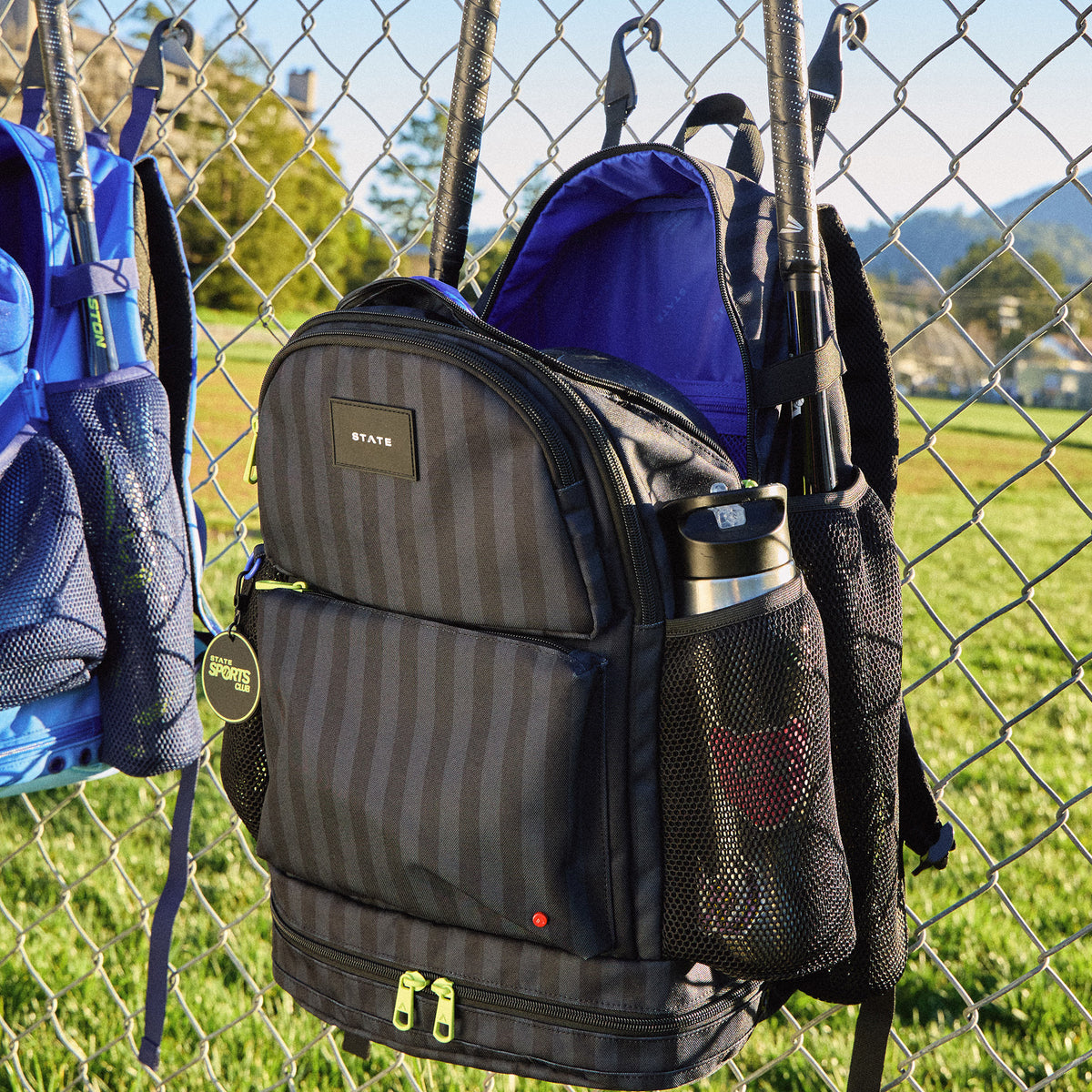 STATE Bags Shea Backpack Black Gray Striped hanging on fence