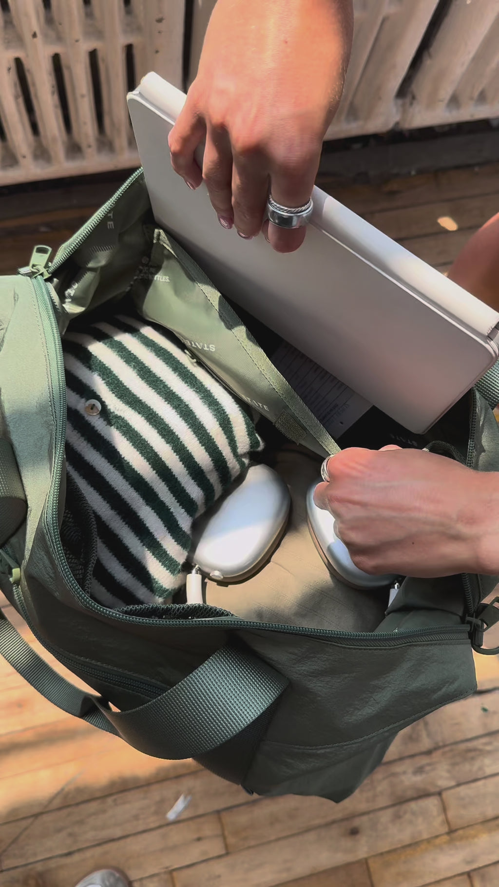 Woman packing Harlow Carryall Olive
